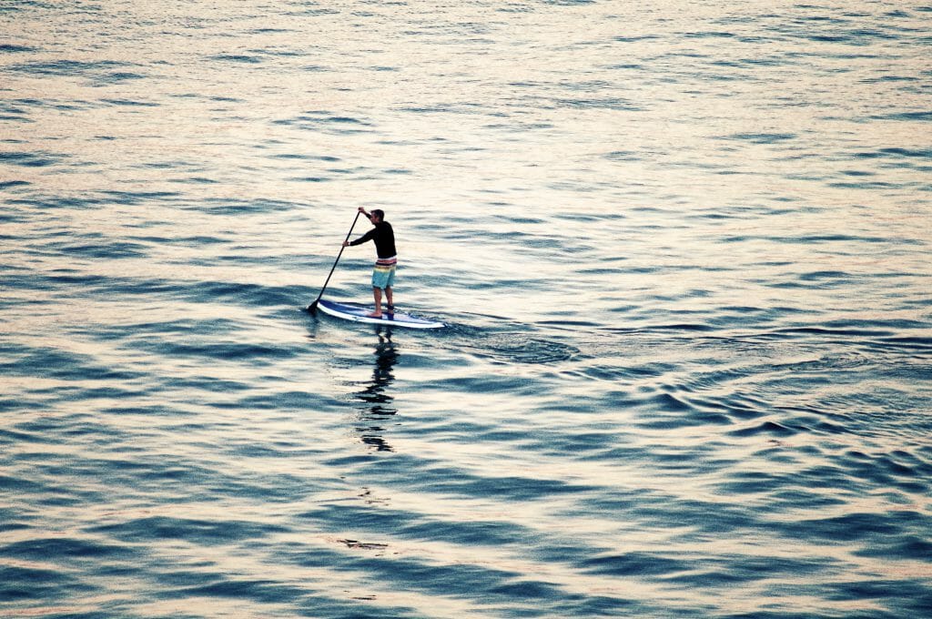 Eine Person, die im Wasser paddelt.